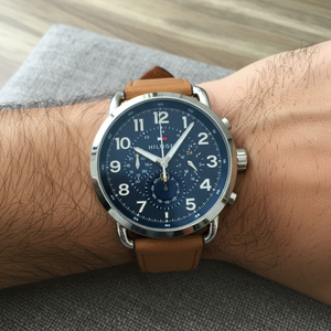 Close up shot of Tommy Hilfiger 1791424 watch on wrist showing the bold numerals on blue dial