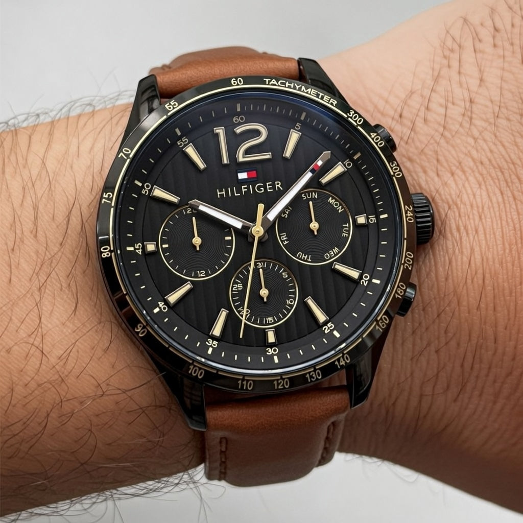 Close up shot of Tommy Hilfiger 1791470 watch on wrist showing the black multifunction dial