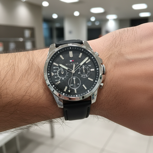 Close up shot of Tommy Hilfiger 1791563 on wrist showing the black dial with multi-function sub-dials and luminous hands