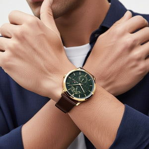 Male model wearing Tommy Hilfiger 1791607 gold watch with a classic outfit