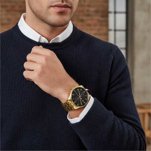 Male model wearing Tommy Hilfiger 1791708 gold watch with a luxury formal outfit