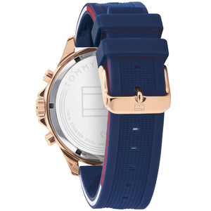 Left side perspective of the gold case and blue rubber strap on the Tommy Hilfiger watch