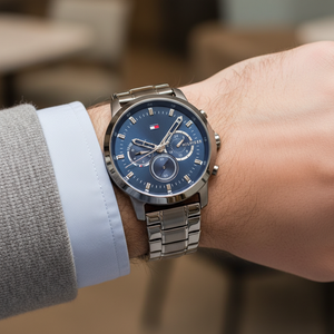 Close up shot of Tommy Hilfiger 1791796 watch on wrist showing the gunmetal finish and blue multifunction dial