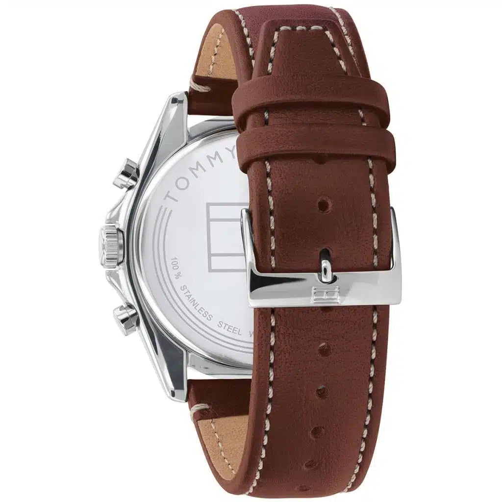 Left side perspective of the silver case and detailed stitching on the brown leather strap of the Tommy Hilfiger watch