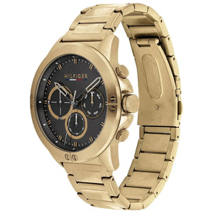 Man wearing Tommy Hilfiger Harley gold metal watch for a sharp, bold, and luxurious everyday look