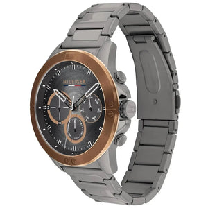Angled view of Tommy Hilfiger 1791892 highlighting the polished gold-tone bezel and integrated gunmetal stainless steel bracelet
