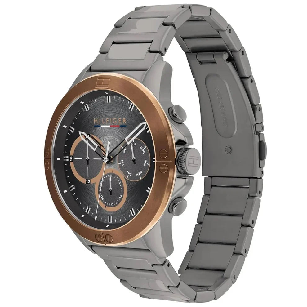 Angled view of Tommy Hilfiger 1791892 highlighting the polished gold-tone bezel and integrated gunmetal stainless steel bracelet