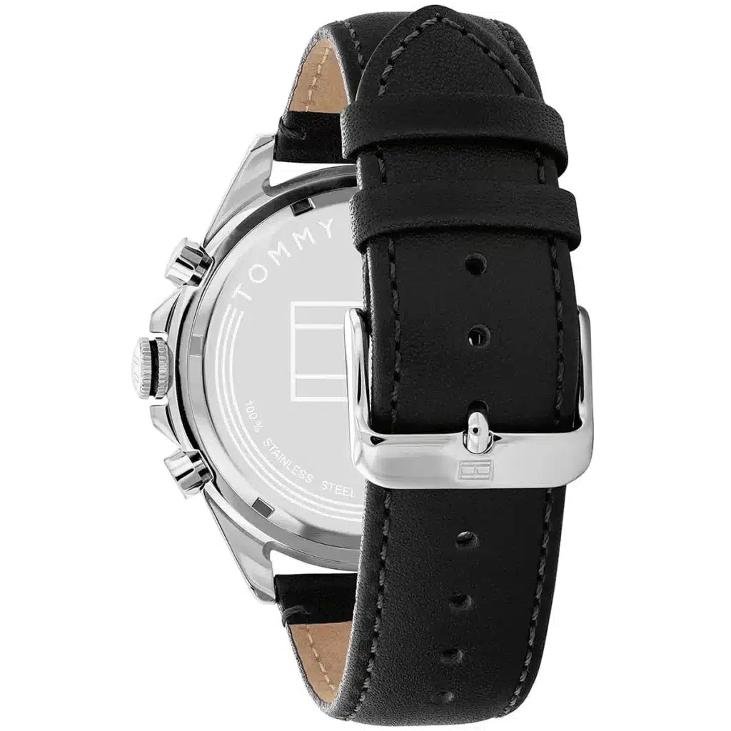 Left side perspective of the silver case and detailed stitching on the black leather strap of the Tommy Hilfiger watch