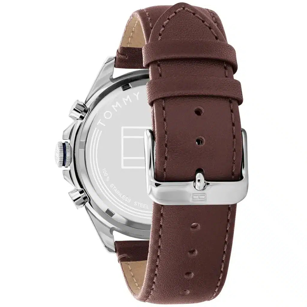 Left side perspective of the silver case and detailed stitching on the brown leather strap of the Tommy Hilfiger watch