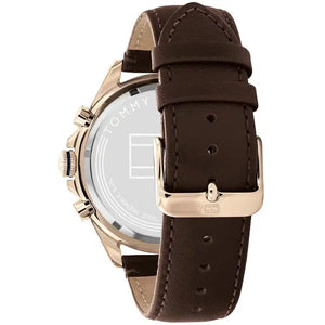Left side perspective of the gold case and detailed stitching on the brown leather strap of the Tommy Hilfiger watch