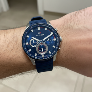 Close up shot of Tommy Hilfiger 1791970 watch on wrist showing the blue tachymeter dial