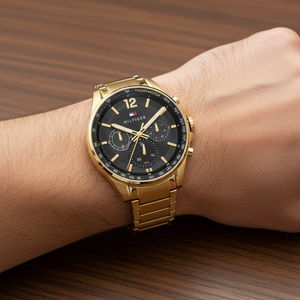 Close up shot of Tommy Hilfiger 1791974 on wrist showing the black dial with gold-tone hands and sub-dials