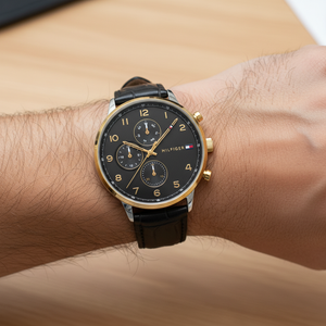 Close up shot of Tommy Hilfiger 1791986 watch on wrist showing the gold Arabic numerals