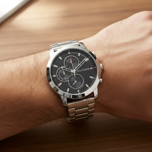 Close up shot of Tommy Hilfiger 1792048 watch on wrist showing the black multifunction dial