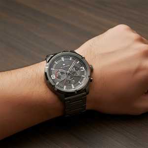 Close up shot of Tommy Hilfiger 1792071 on wrist showing the dark grey dial with multi-function sub-dials and striking red details