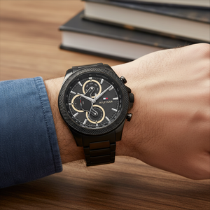 Close up shot of Tommy Hilfiger 1792081 on wrist showing the textured black dial with multi-function sub-dials and gold-tone hands