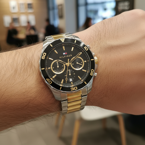 Close up shot of Tommy Hilfiger 1792095 watch on wrist showing the black bezel and dual time sub-dials