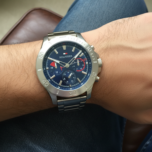 Close up macro view of the navy blue dial and vibrant red hand details of Tommy Hilfiger 1792113