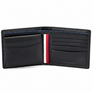 Detailed interior of the Tommy Hilfiger brown leather wallet showing multiple card slots, a secure buttoned coin pocket, and the "Genuine Leather" stamp
