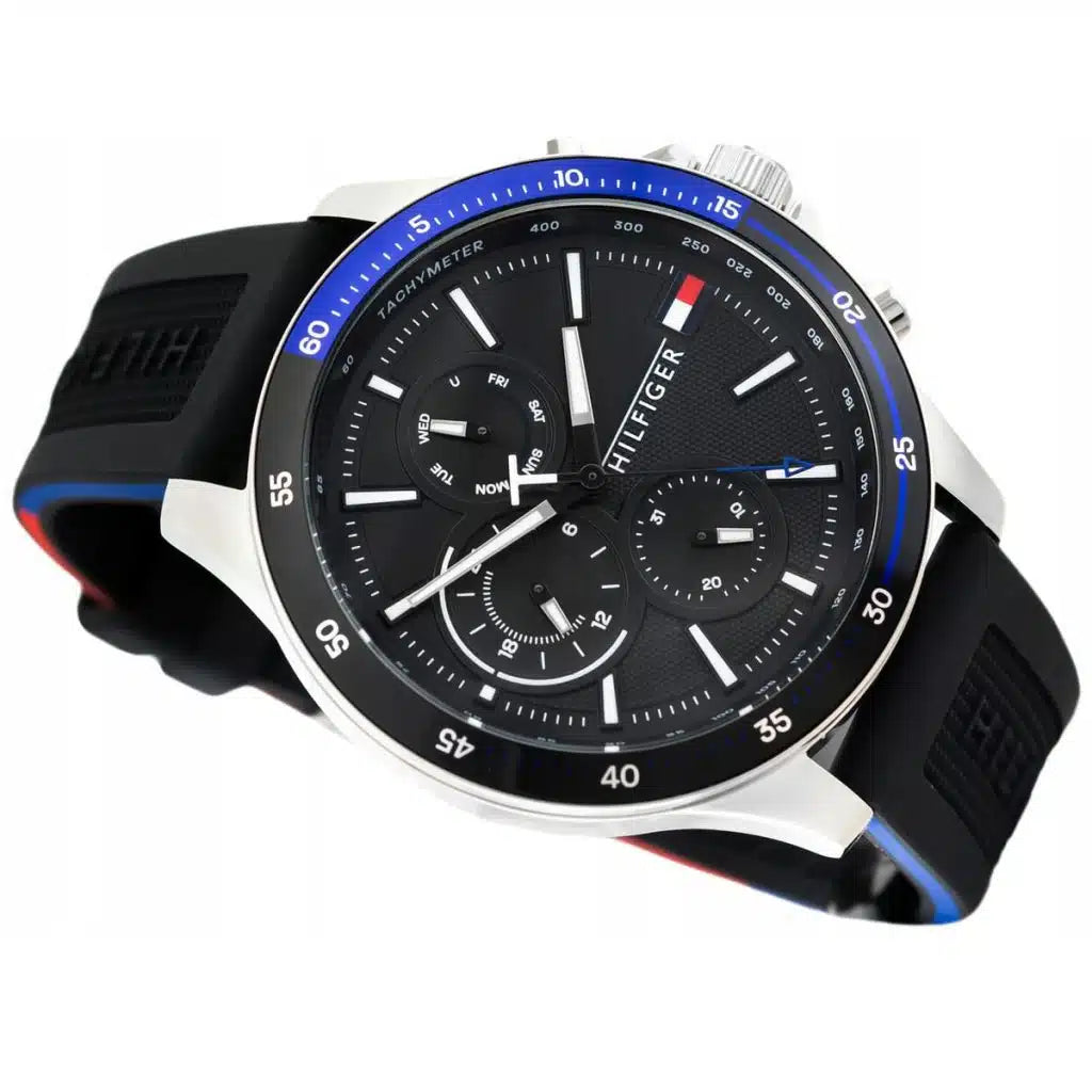 Perspective view of the black dial and silver markers of Tommy Hilfiger Bank watch