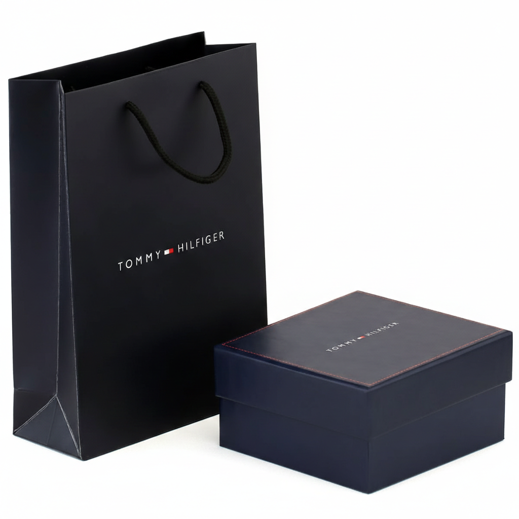Luxury Tommy Hilfiger men's accessory gift packaging featuring a navy blue branded box with red stitching and a matching premium shopping bag