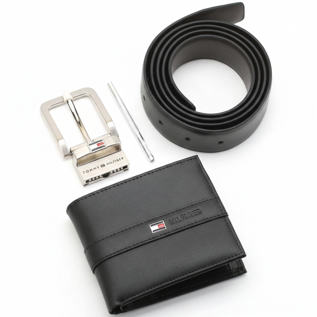 Side perspective of a standing Tommy Hilfiger black leather bifold wallet next to a rolled leather belt and a polished silver metal buckle