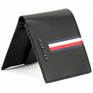 Standing view of Tommy Hilfiger black leather wallet featuring a horizontal tricolor signature stripe and silver metal logo on the front