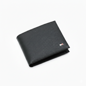 High-detail close-up of the durable Saffiano leather texture and the iconic small enamel flag logo on a Tommy Hilfiger black wallet