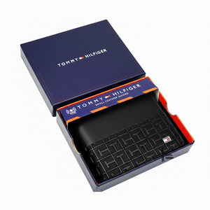 Black wallet with geometric pattern in a Tommy Hilfiger box on a white background