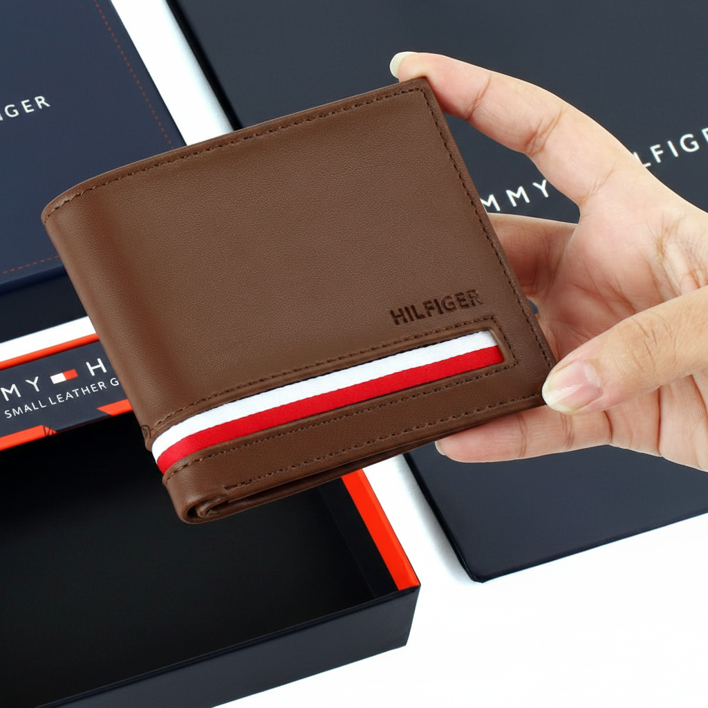 An open display of the Tommy Hilfiger men's brown leather wallet alongside its branded gift box and luxury shopping bag