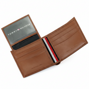 Detailed interior of the Tommy Hilfiger brown leather wallet featuring multiple card slots and a secure button-fastened coin pocket