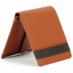 Side view of a standing Tommy Hilfiger camel genuine leather bifold wallet showcasing its elegant profile and two-tone color design