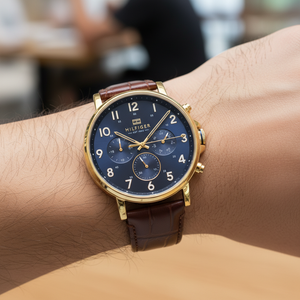Close up of navy blue dial and gold-tone markers of Tommy Hilfiger 1710380