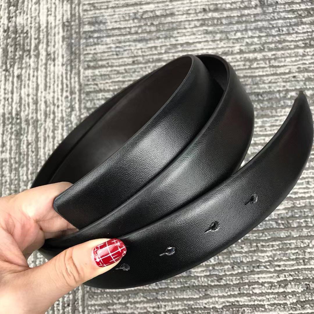 Rolled up Tommy Hilfiger Double Face Leather Belt Strap showing Black and Brown sides