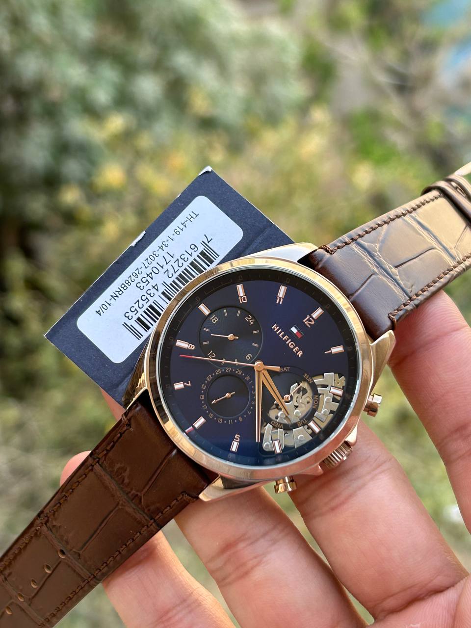 Tommy Hilfiger Henry 1710474 men's watch with two-tone silver and gold case, skeleton dial, and black leather strap