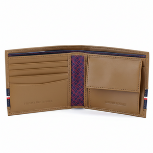 Close-up of the interior of a Tommy Hilfiger tan wallet featuring the "Genuine Leather" embossed stamp and premium card slots