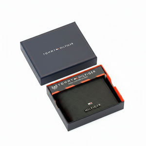 Interior view of an open Tommy Hilfiger men's blackleather wallet featuring card slots on the left and a removable passcase insert with a clear ID window on the right.