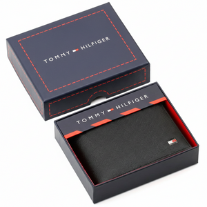 Authentic Tommy Hilfiger men's black Saffiano leather bifold wallet with enamel flag logo, presented in a premium navy branded gift box