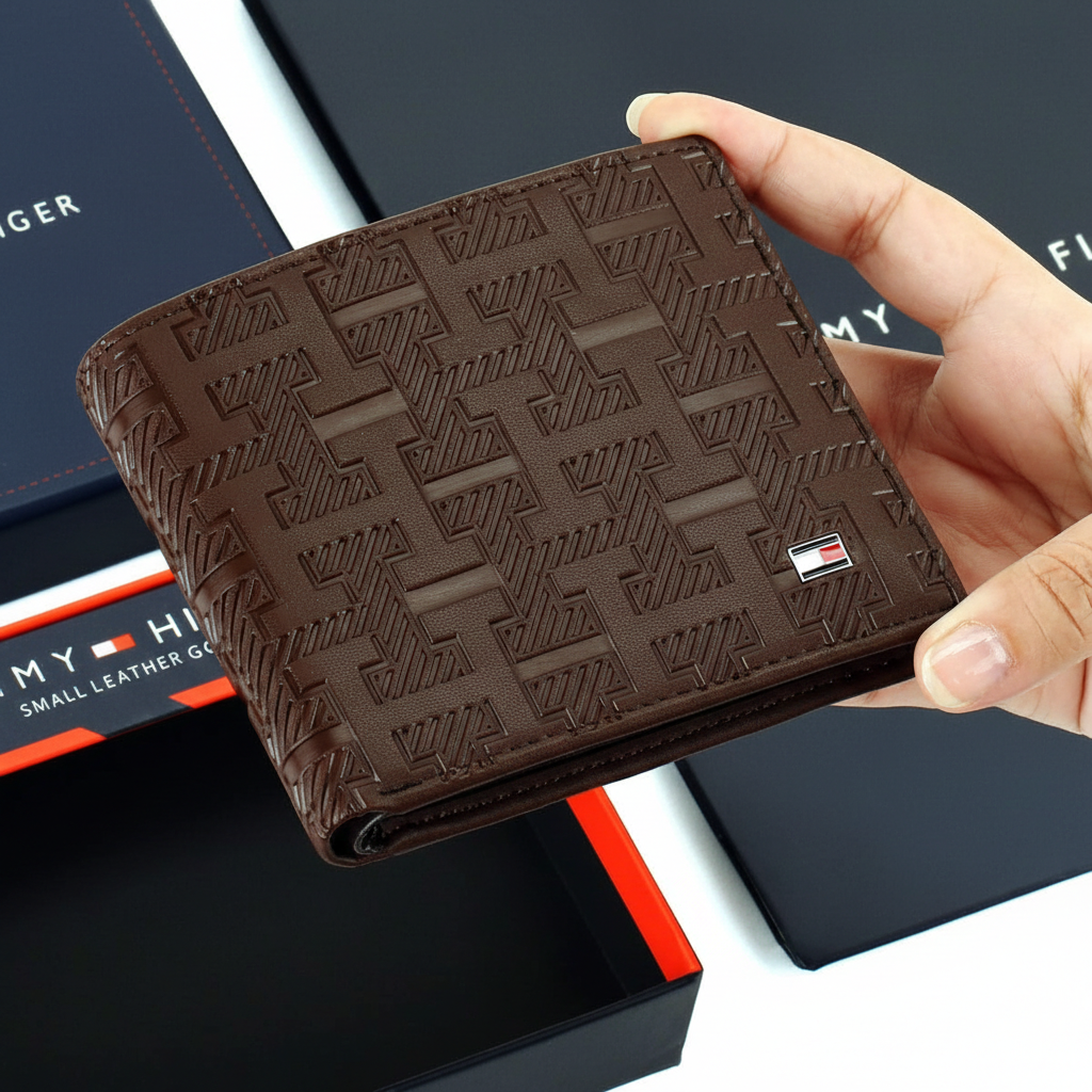 Front view of a Tommy Hilfiger men's brown leather wallet featuring an all-over embossed H monogram pattern and a small enamel flag logo