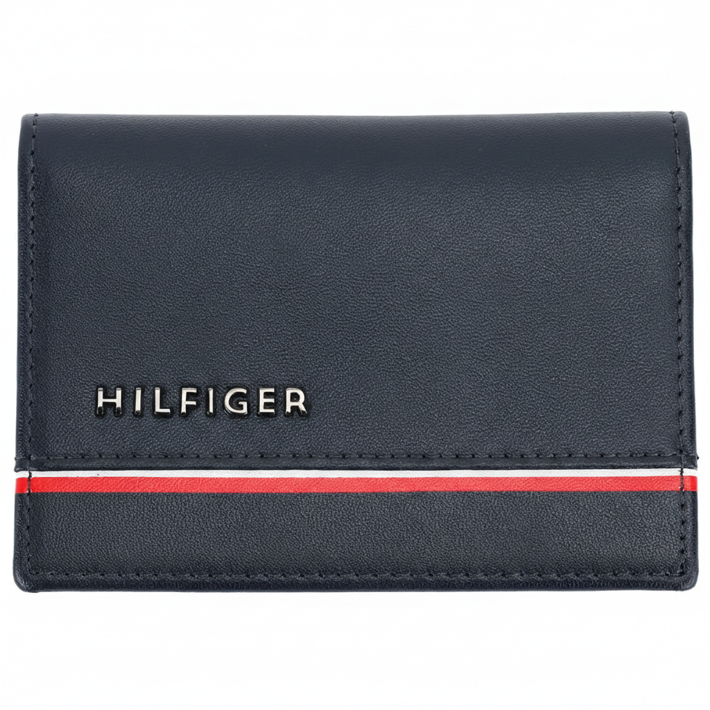 Front view of a Tommy Hilfiger men's navy blue genuine leather card case wallet with a silver-toned metal logo and iconic horizontal flag stripe