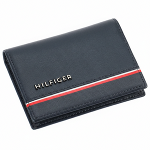 Front view of a Tommy Hilfiger men's navy blue genuine leather card case wallet with a silver-toned metal logo and iconic horizontal flag stripe