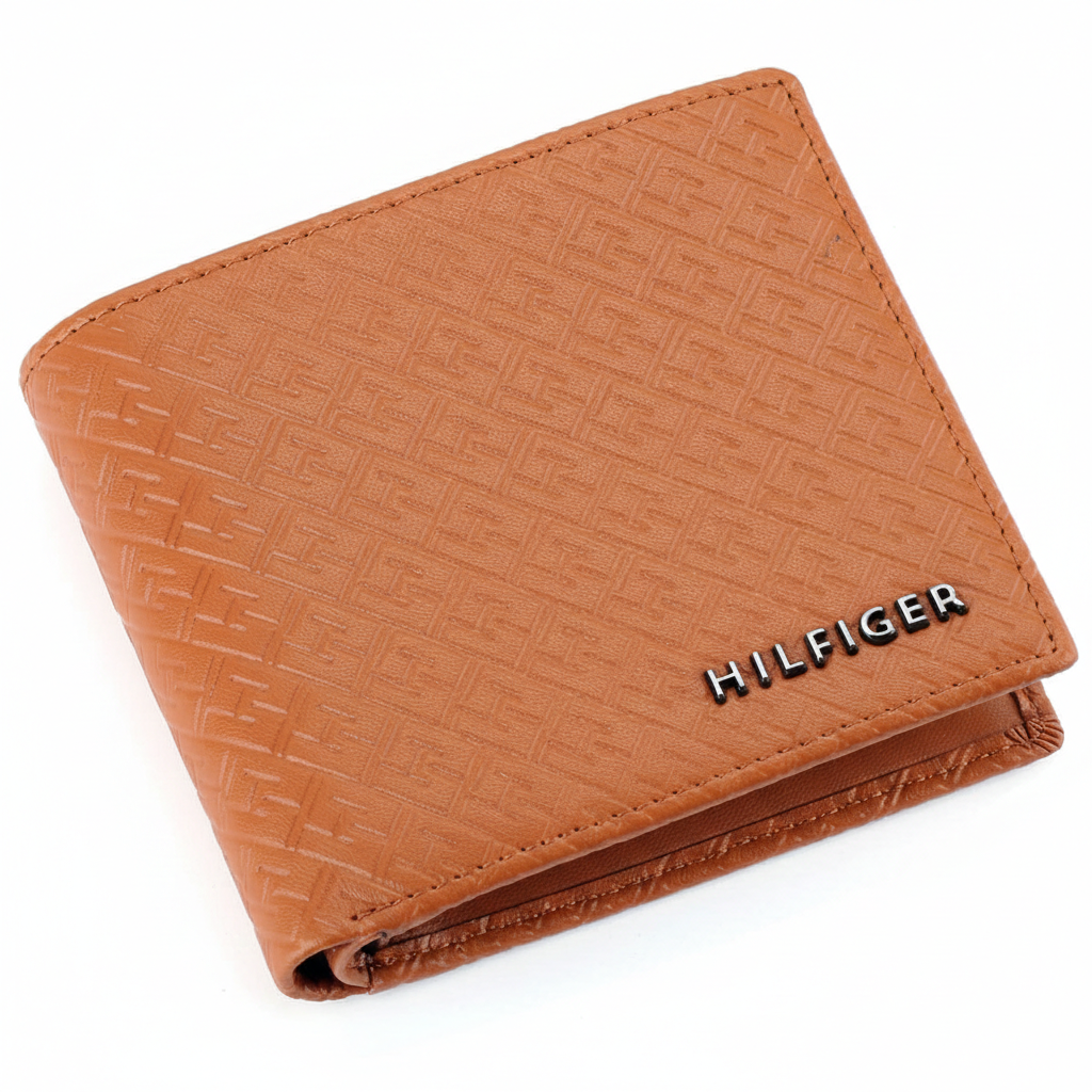 Perspective view of a Tommy Hilfiger tan genuine leather bifold wallet showcasing the textured Hilfiger logo pattern and premium finish