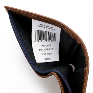 Inside view of the Tommy Hilfiger brown leather wallet currency compartment showing the original white tracking barcode label and navy fabric lining