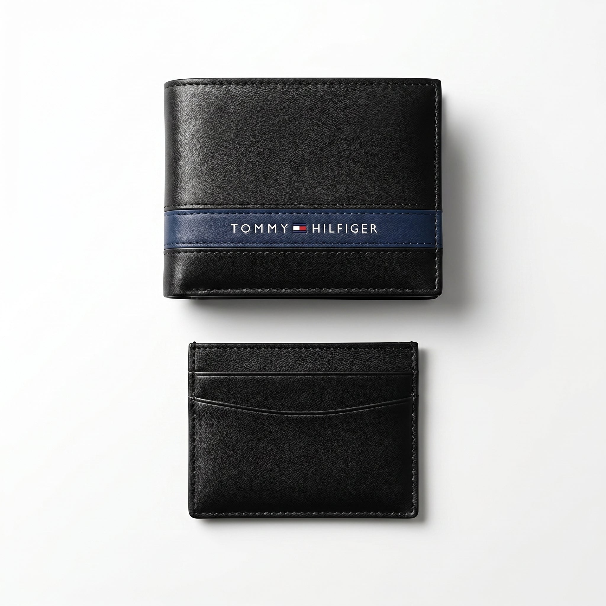 Straight front view product photography of the Tommy Hilfiger mirror original black leather wallet alongside its matching slim card case with vertical ribbon details