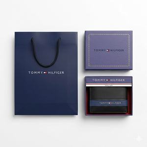 Full premium presentation of the Tommy Hilfiger mirror original smooth black leather wallet with its matching detachable card case set, navy gift box, and shopping bag