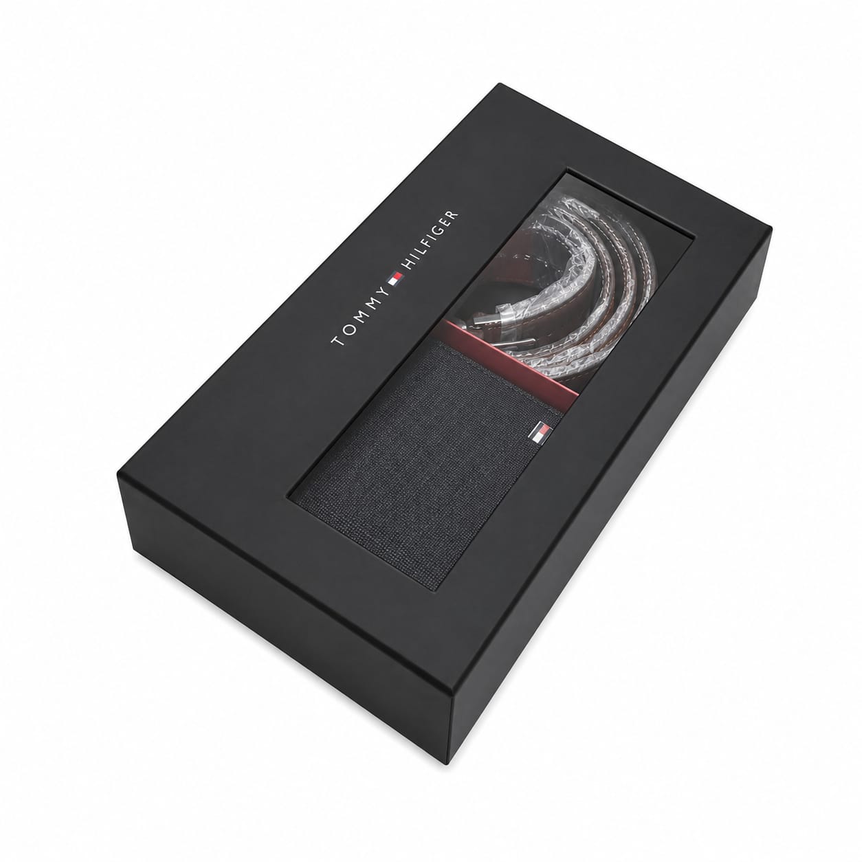Top-down studio product view of the closed Tommy Hilfiger premium presentation gift box featuring a transparent window showcasing the smooth wallet and reversible belt buckle