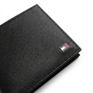 Live professional angled product photograph of the sleek Tommy Hilfiger smooth black leather bifold wallet over clean white background