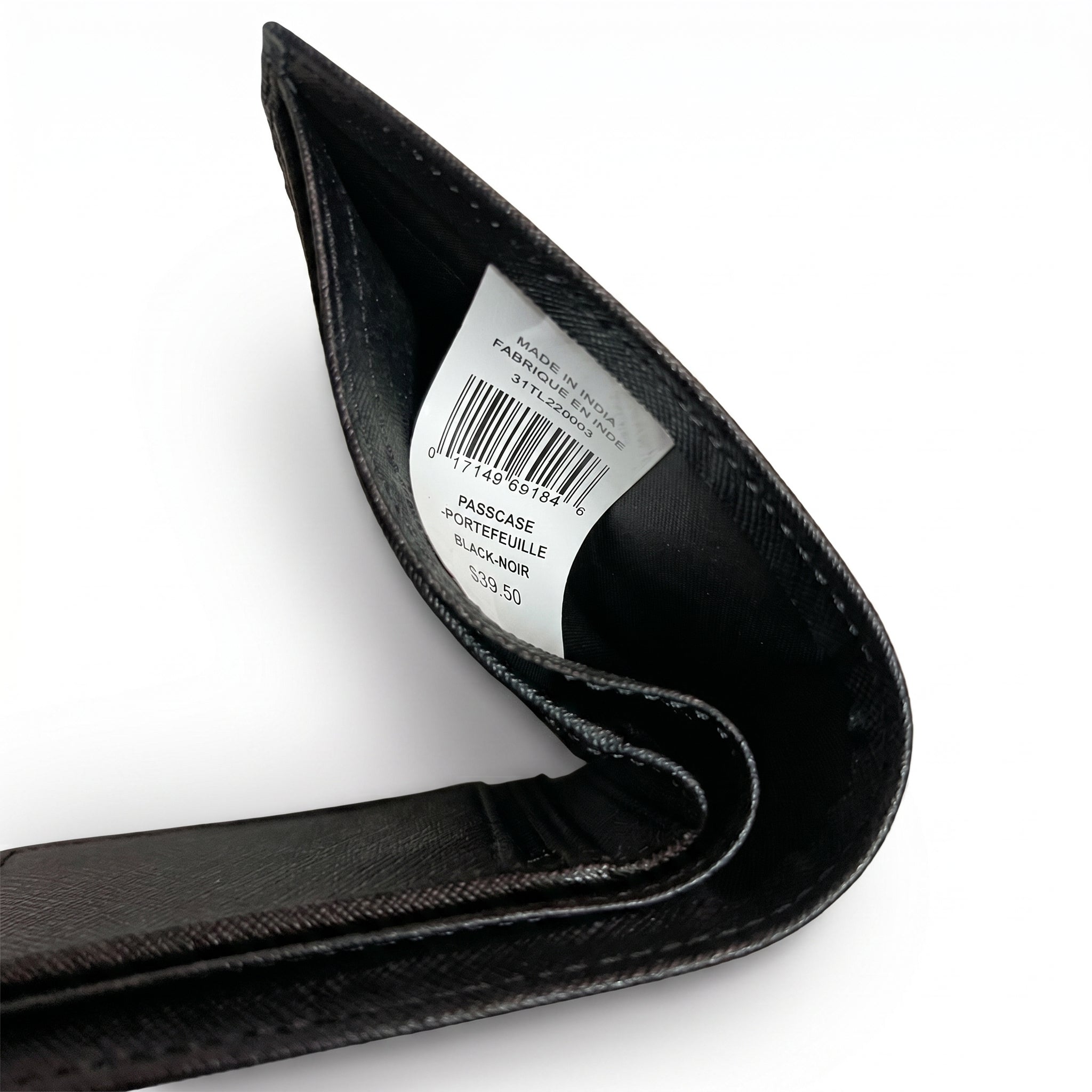 High-angle interior view of the opened Tommy Hilfiger textured leather wallet currency compartment highlighting the original white tracking barcode label and fabric lining