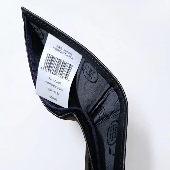 Live high-angle view of the Tommy Hilfiger textured leather wallet currency compartment displaying the navy fabric lining and original tracking barcode label