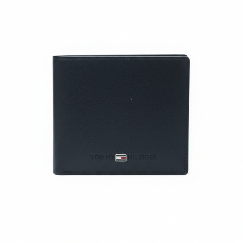 Front view of Tommy Hilfiger navy blue smooth leather wallet featuring centered horizontal text and flag logo